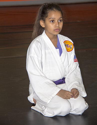 Student Kneeling in Traditional Class